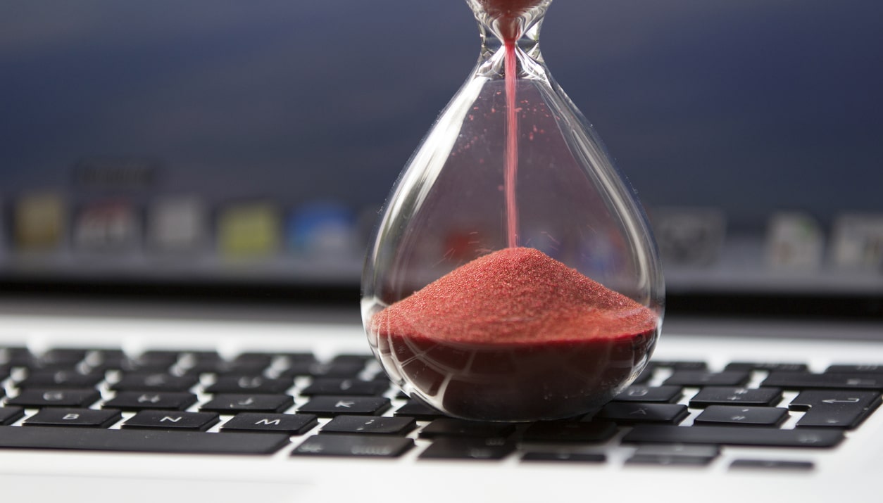 An hourglass sitting on keyboard to suggest a slow website