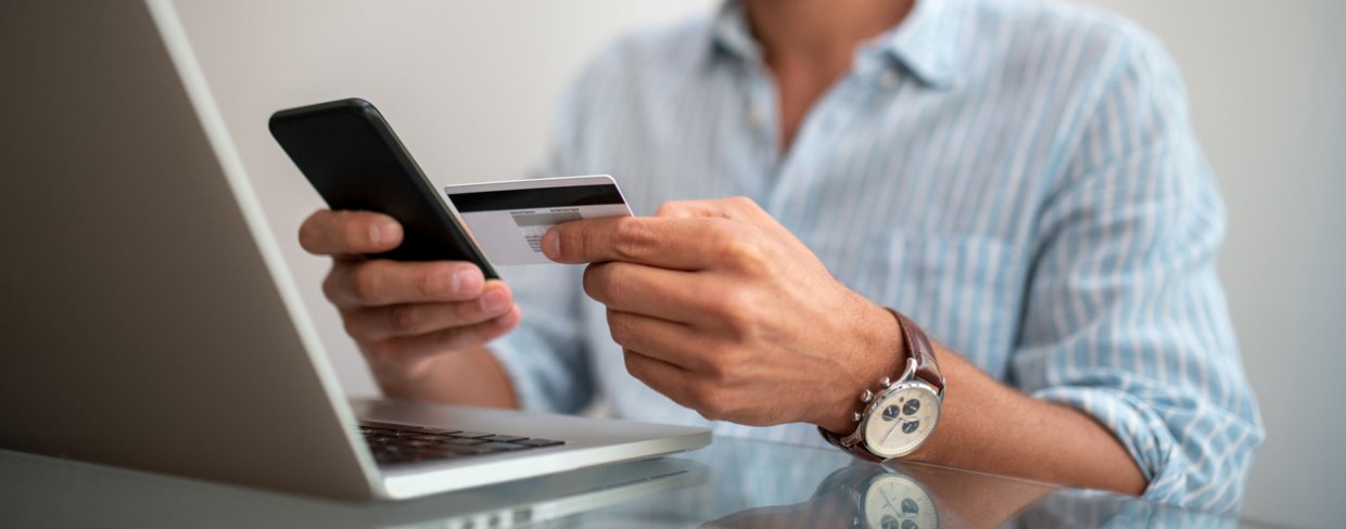 Business owner entering credit card number into smartphone