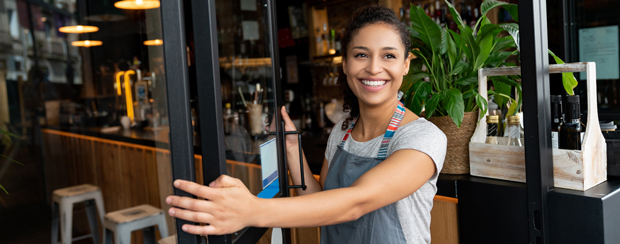 Business owner greeting customers at door